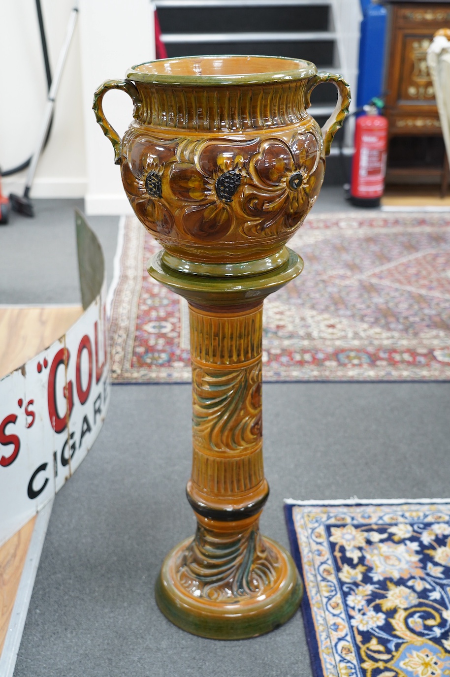 A terracotta jardiniere on stand with incised stylised floral decoration, 102cm high. Condition - good